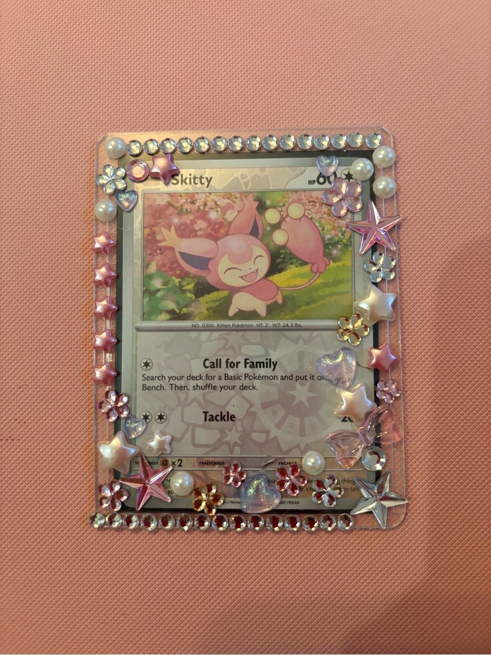 Pokemon Skitty Trading Card with decorated toploader